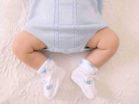 Preparativi battesimo — accessori e vestiti del bambino disposti per le foto
